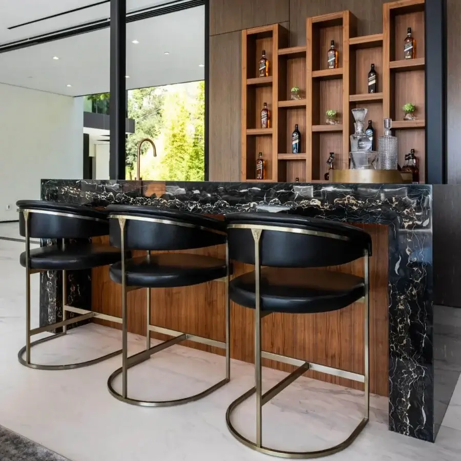 Superior Visionnaire Clem stool upholstered in dark textile with a satin-finish brass pipe frame and circular base