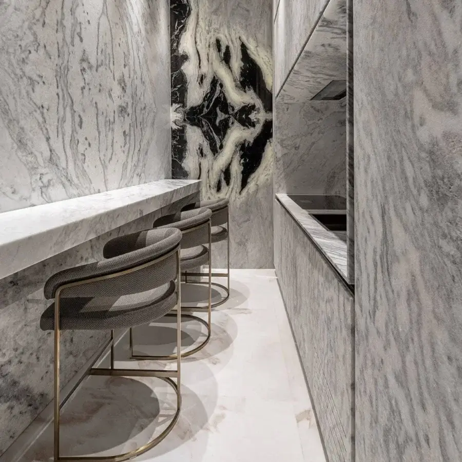 Architectural Visionnaire Clem stool with muted grey textile upholstery and polished brass frame