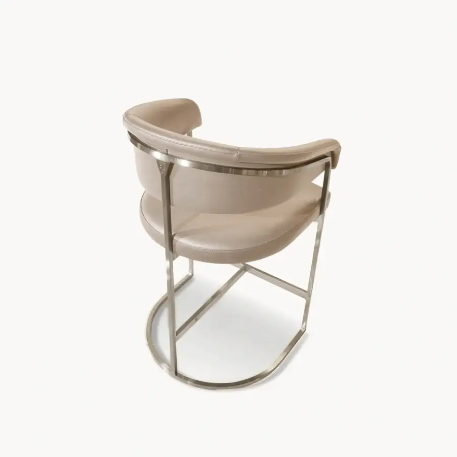 Distinguished Visionnaire Clem stool crafted with a squared brass pipe frame and curved plywood core upholstered in matte beige fabric
