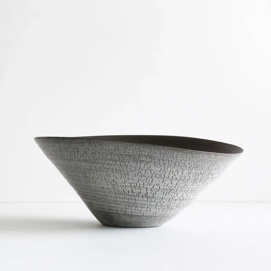Distinguished Rina Menardi Campanelle centerpiece crafted in baked clay with a textured exterior and glossy black interior