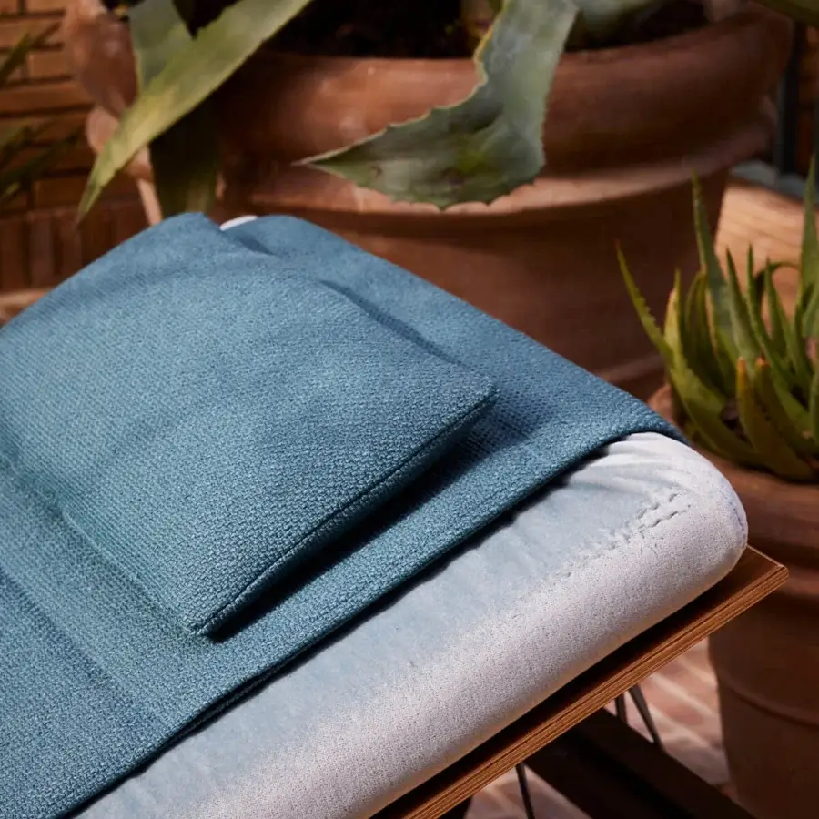 Refined Giorgetti Gea lounger with carob powder-coated aluminum and breathable teal textile cushioning