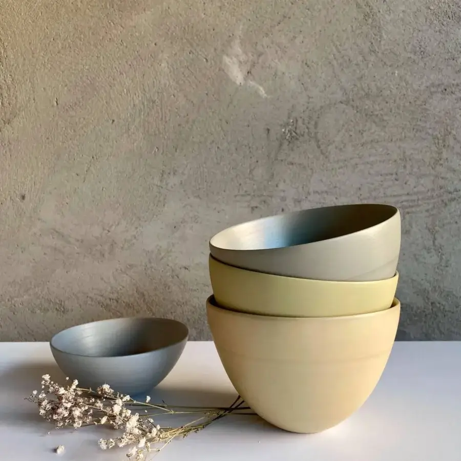 Distinguished Rina Menardi Ciotole bowls crafted from baked clay in a greyish-olive green with a smooth matte finish