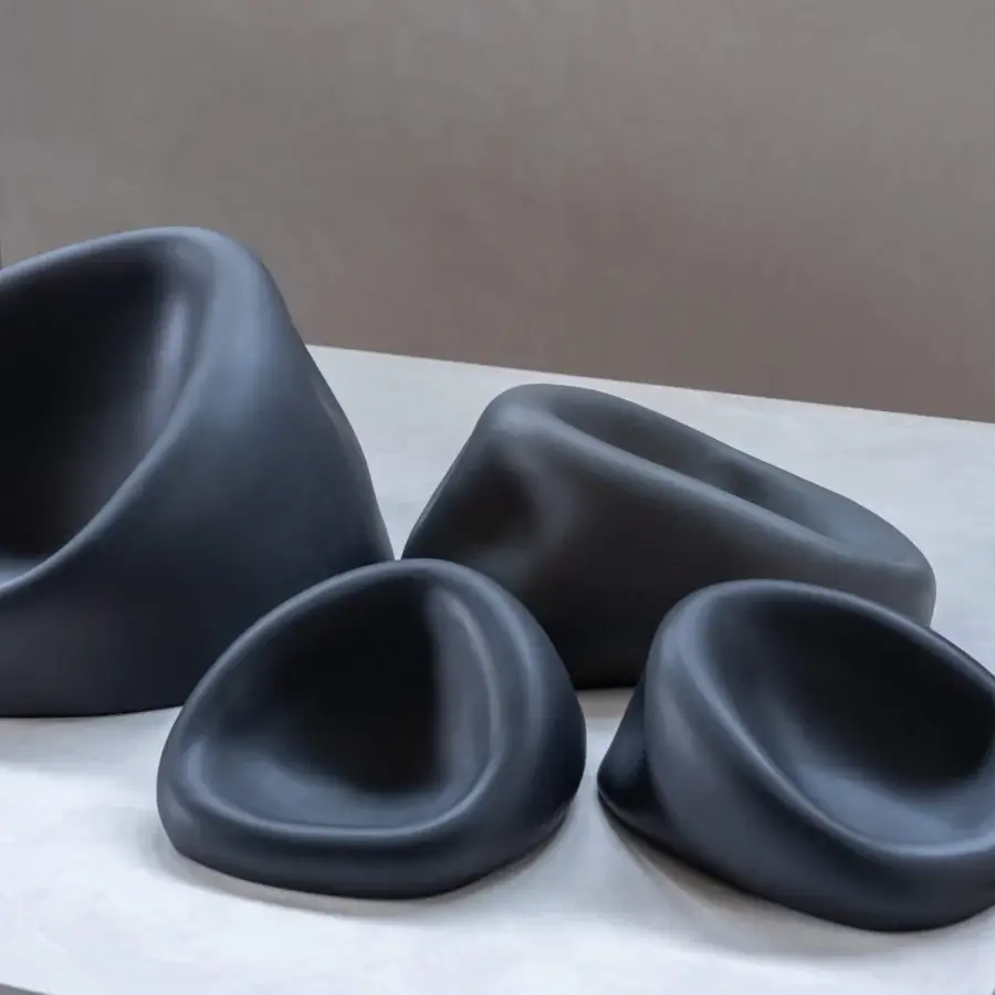 Elegant Rina Menardi Clio centerpiece crafted in baked clay with a high-gloss muted gray finish and fluid sculptural forms