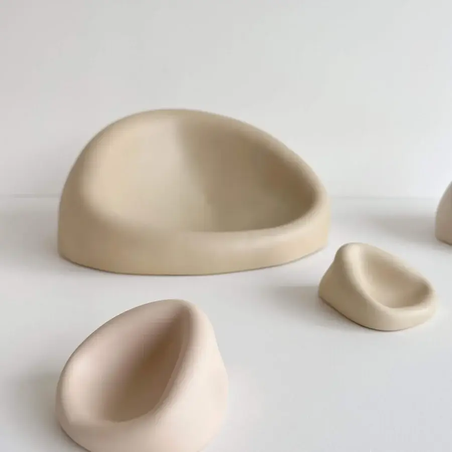 Elegant Rina Menardi Clio centerpiece crafted from baked clay with organic asymmetrical forms and a pale beige tone