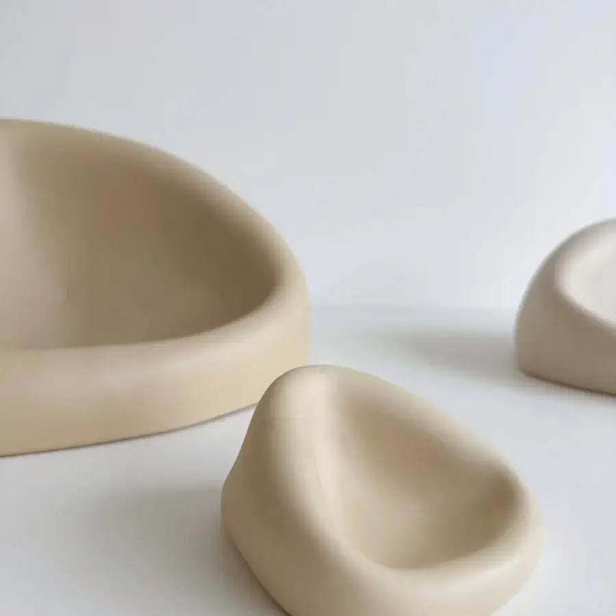 Distinguished Rina Menardi Clio centerpiece crafted in Italy from baked clay with smooth organic curves and a pale beige tone