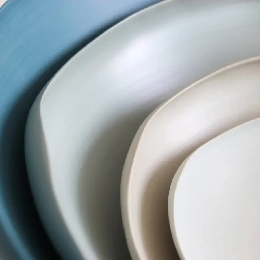 Distinguished Rina Menardi Conchiglie centerpiece crafted in baked clay with a gradient from pale cream to muted dusty blue and matte finish