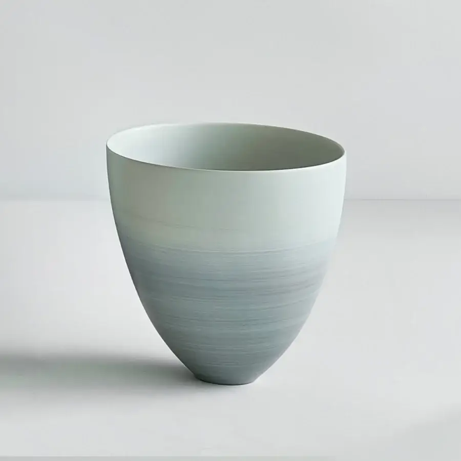Distinguished Rina Menardi Coppe vase crafted from baked clay with a gradient of muted blue-grey to darker grey hues