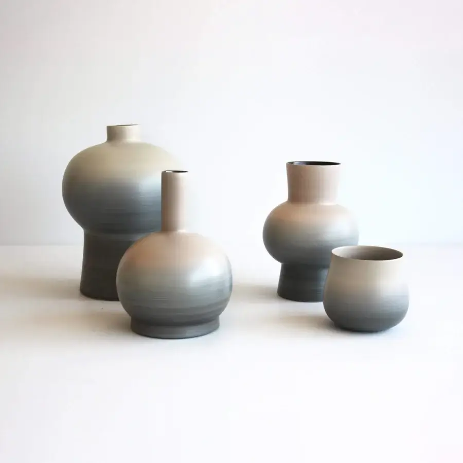 Distinguished Rina Menardi Delos vase set in baked clay exhibits a gradient from light gray to charcoal with organic silhouettes
