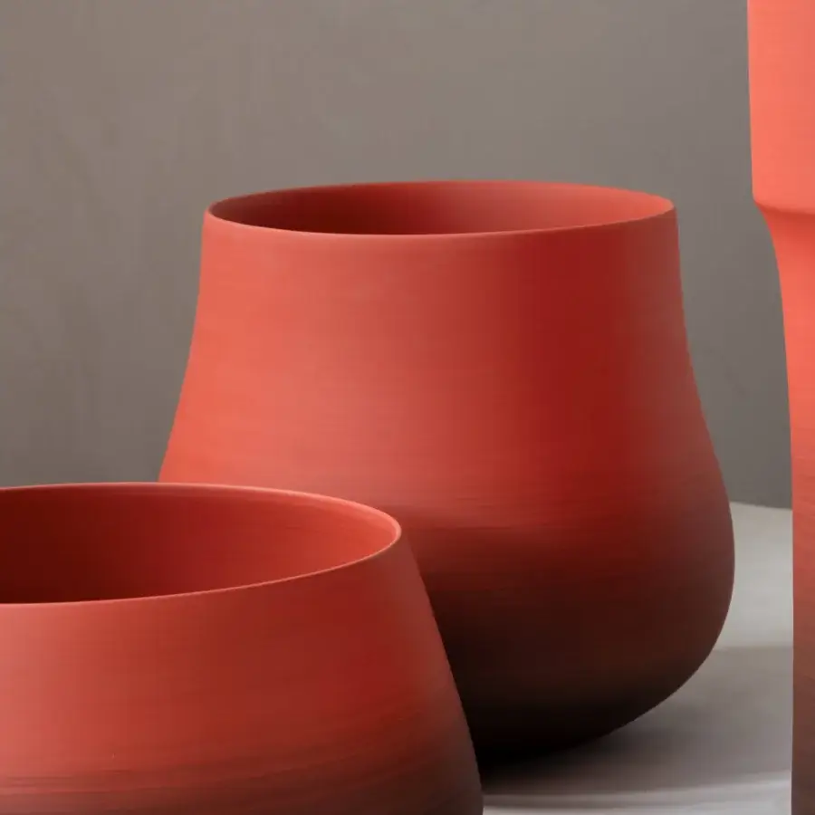 Superior Rina Menardi Delos vase sculpted from baked clay with a muted terracotta red and smooth matte finish