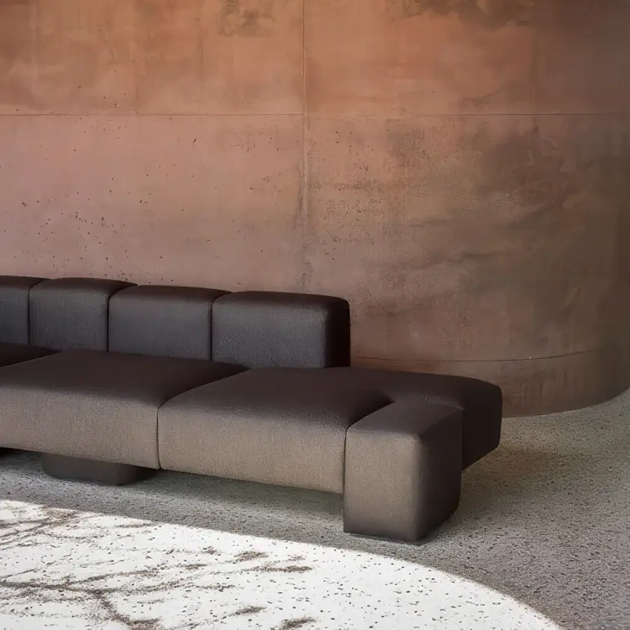 Distinguished Carpanese Home Cusco sofa crafted with dark taupe textile upholstery and a matte finish exhibiting sculptural volumes