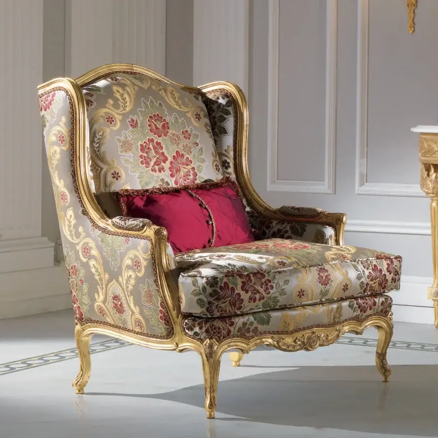 Distinctive Armando Rho A1157 lounge chair with red, green, and beige floral textile upholstery and glossy golden wooden frame