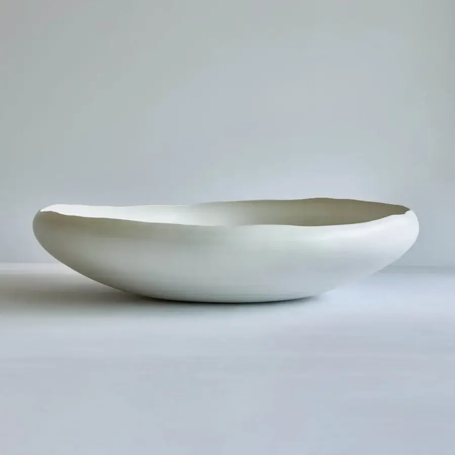 Exclusive Rina Menardi Luna centerpiece, a handcrafted decorative vessel sculpted in pale cream matte ceramic with organic form