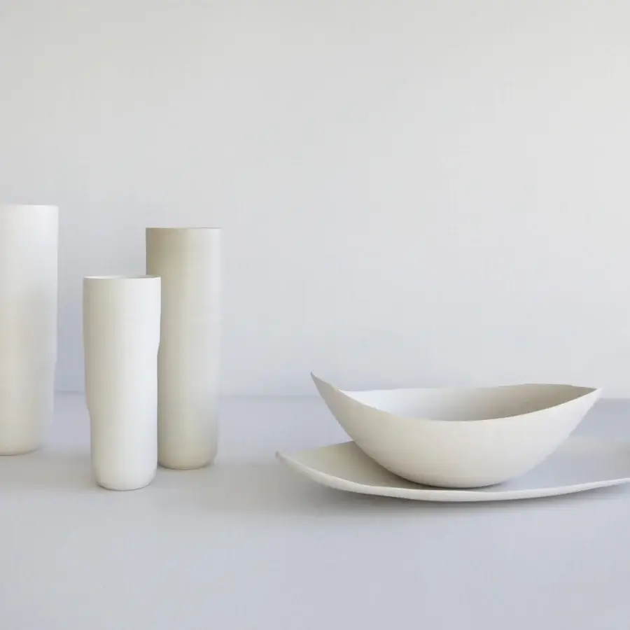 Exclusive Rina Menardi Menhir vase collection in matte cream ceramic with organically shaped bowl and asymmetrical plate