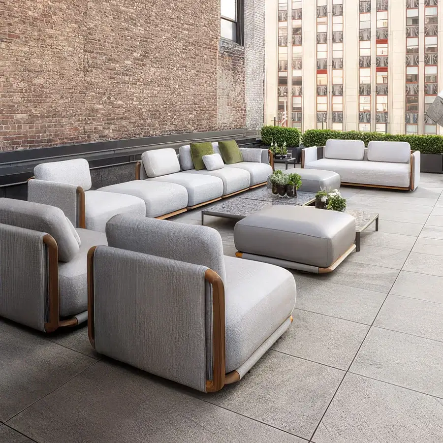 Refined Giorgetti Moorea lounge chair with pewter-painted stainless steel frame and light gray textured fabric cushions with painted teak inserts