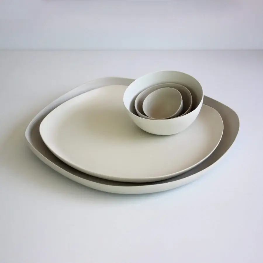 Elegant Rina Menardi Quadritondi centerpiece crafted in Italy with nested bowls and plates in pale ceramic and smooth matte surfaces