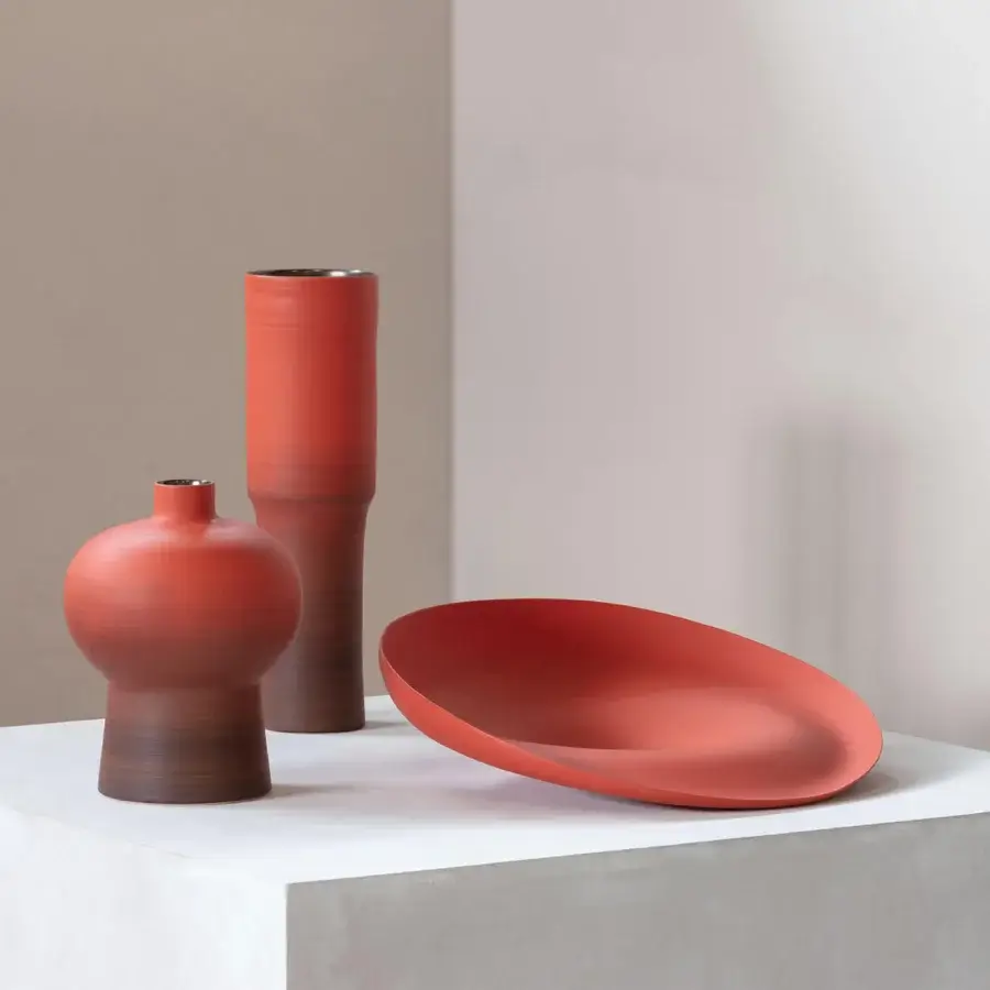 Distinguished Rina Menardi Totem vase sculpted from subtly textured synthetic material in a contemporary terracotta hue with matte finish