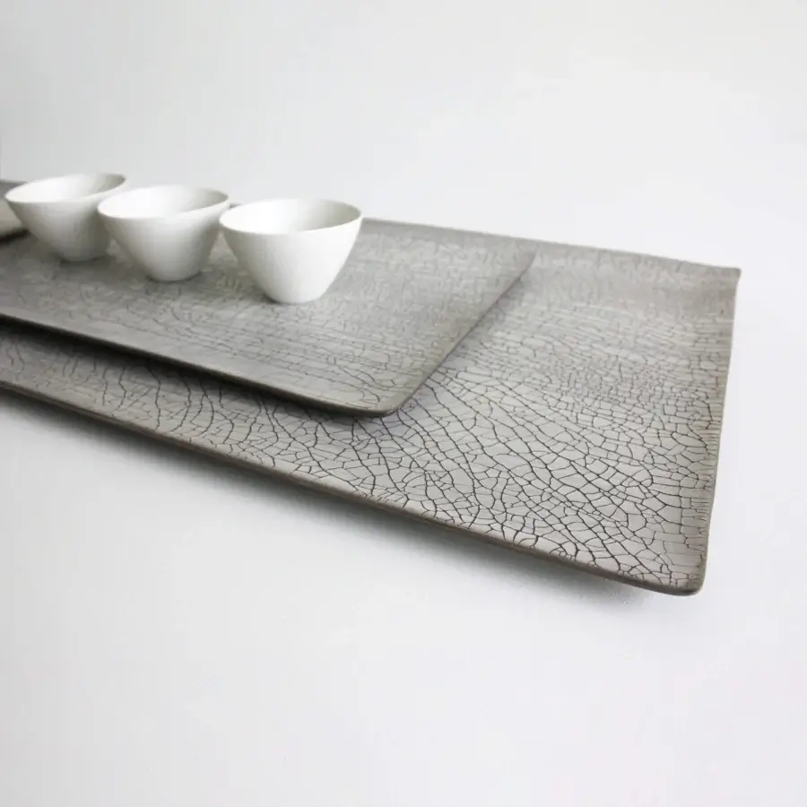 Distinguished Rina Menardi Vassoi Rettangolari tray set with uniquely cracked muted gray finish crafted for decorative use