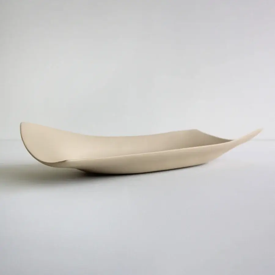 Superior Rina Menardi Vassoi Rettangolari Onde tray in pale beige with a smooth matte finish and flowing asymmetrical silhouette