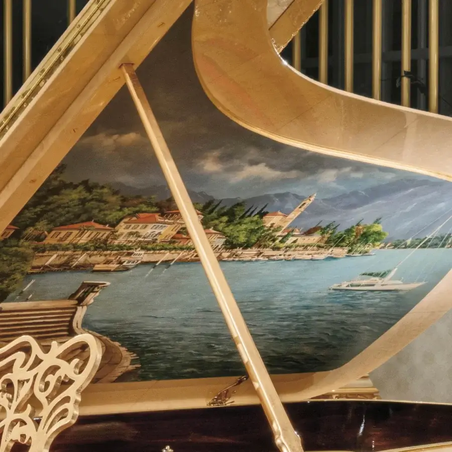 Distinguished Riva Mobili D'Arte 19800 piano built in light-toned wood with glossy finish and hand-carved coastal town scene