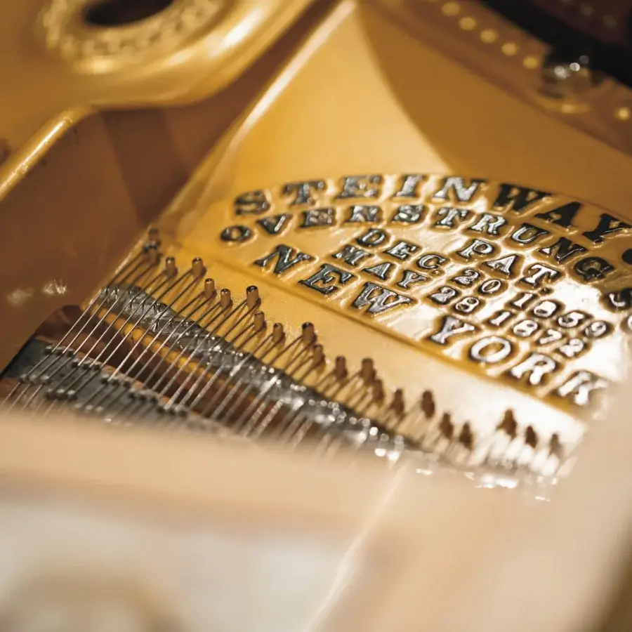 Superior Riva Mobili D'Arte 19800 piano crafted in golden-yellow glossy wood with brass and silver string details and mother-of-pearl inlays