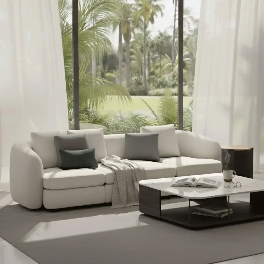 Elegant Carpanelli Grantour sofa with smooth textile upholstery in off-white and teal-green cushions and rounded edges
