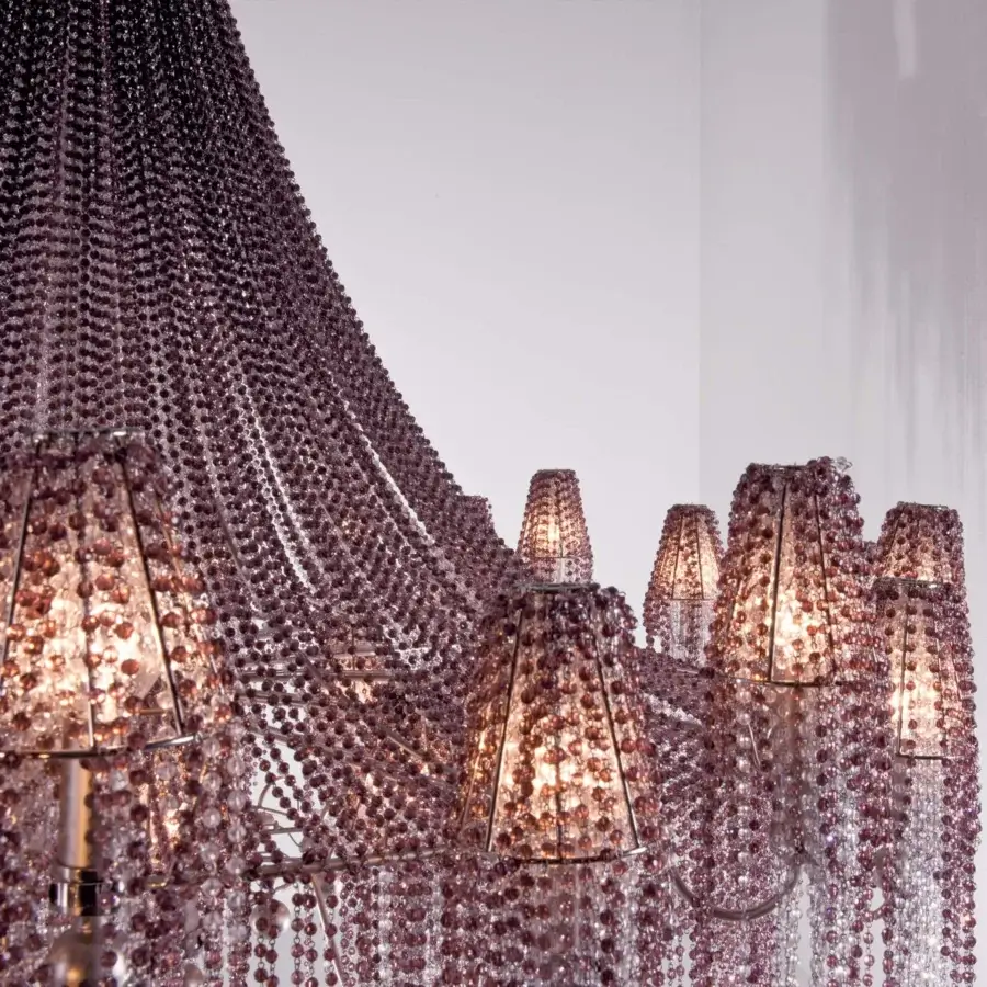 Lavish Patrizia Garganti Burlesque chandelier with cascading pearl strands over polished metallic structure in pale rose hues