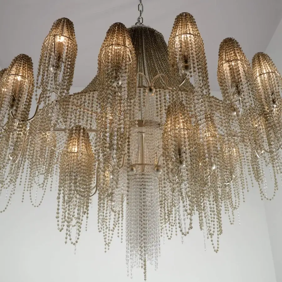 Lavish Patrizia Garganti Burlesque chandelier crafted in Italy with clear glass crystals and warm golden metal finish