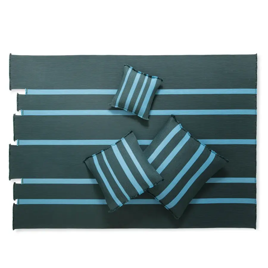 Innovative Giorgetti Nisida rug crafted with horizontal stripes in dark teal and sky blue recyclable polypropylene braids with light blue binding