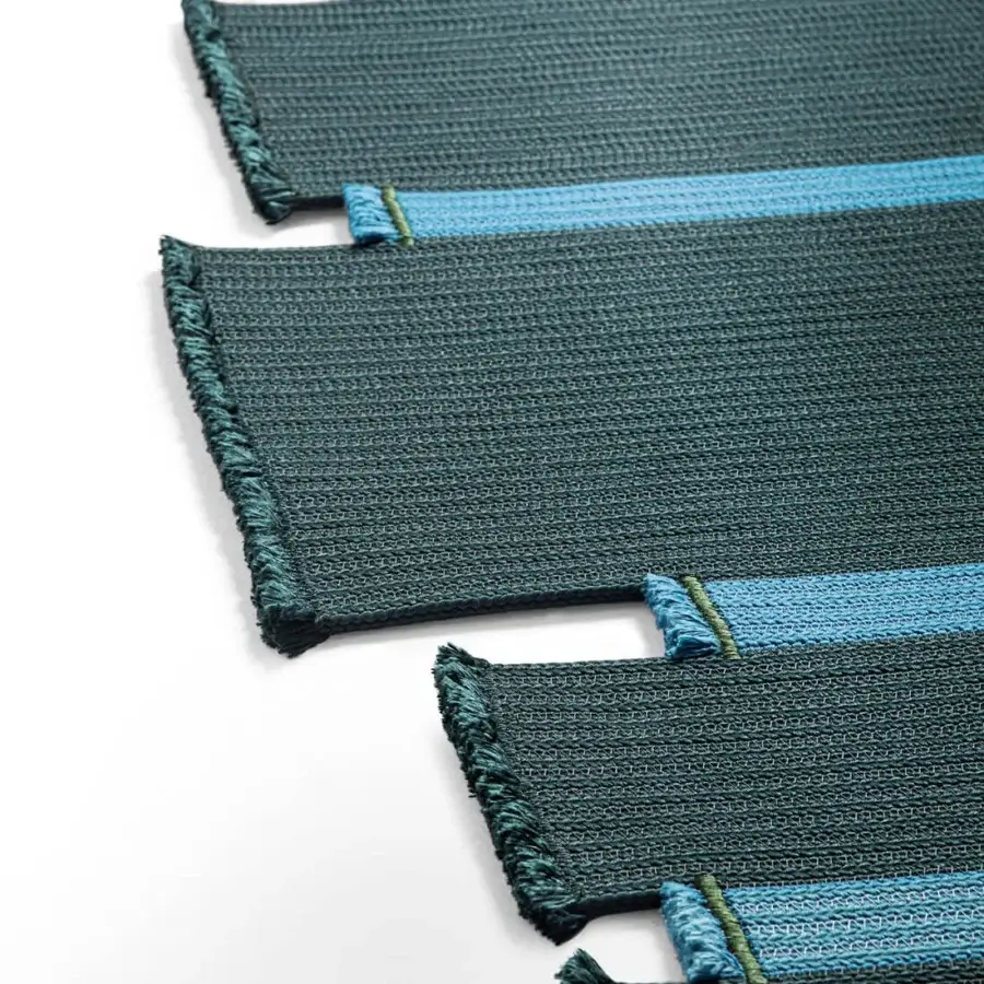 Superior Giorgetti Nisida rug crafted with braids in bright turquoise and dark teal polypropylene, finished with a tone-on-tone fringe