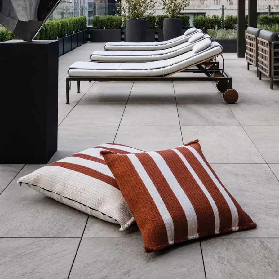 Stylish Giorgetti Nisida cushion crafted with braided reddish-brown and creamy white polypropylene technical yarn with fringe detail