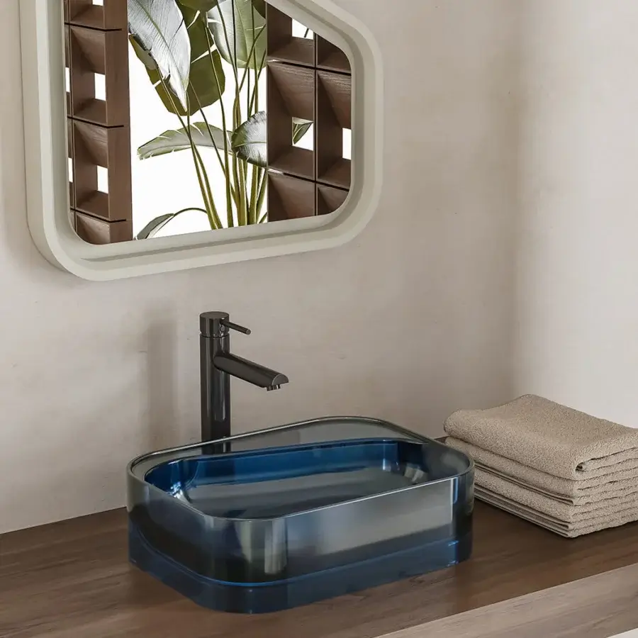 Architectural Norah Design ANBA 01 washbasin crafted in Norahcrystal with a glossy finish and captivating deep blue coloration transitioning to translucent edges