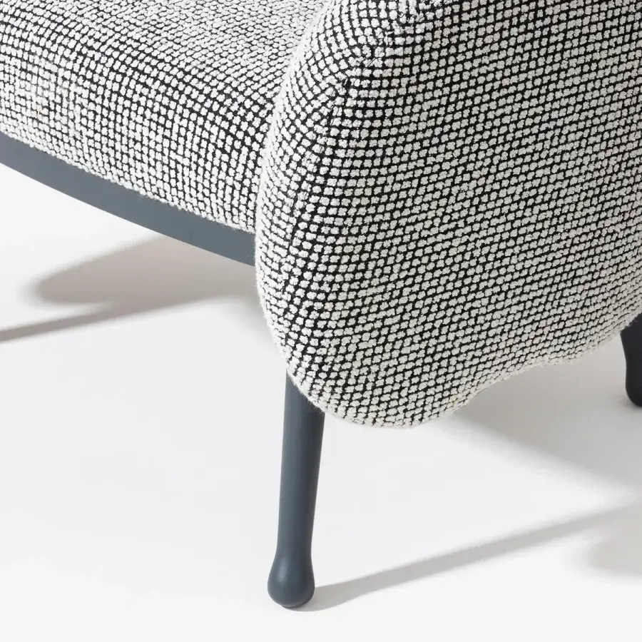 Elegant Billiani Corolla lounge chair with enveloping form and patterned textile upholstery built with worked wood and matte gray metal legs