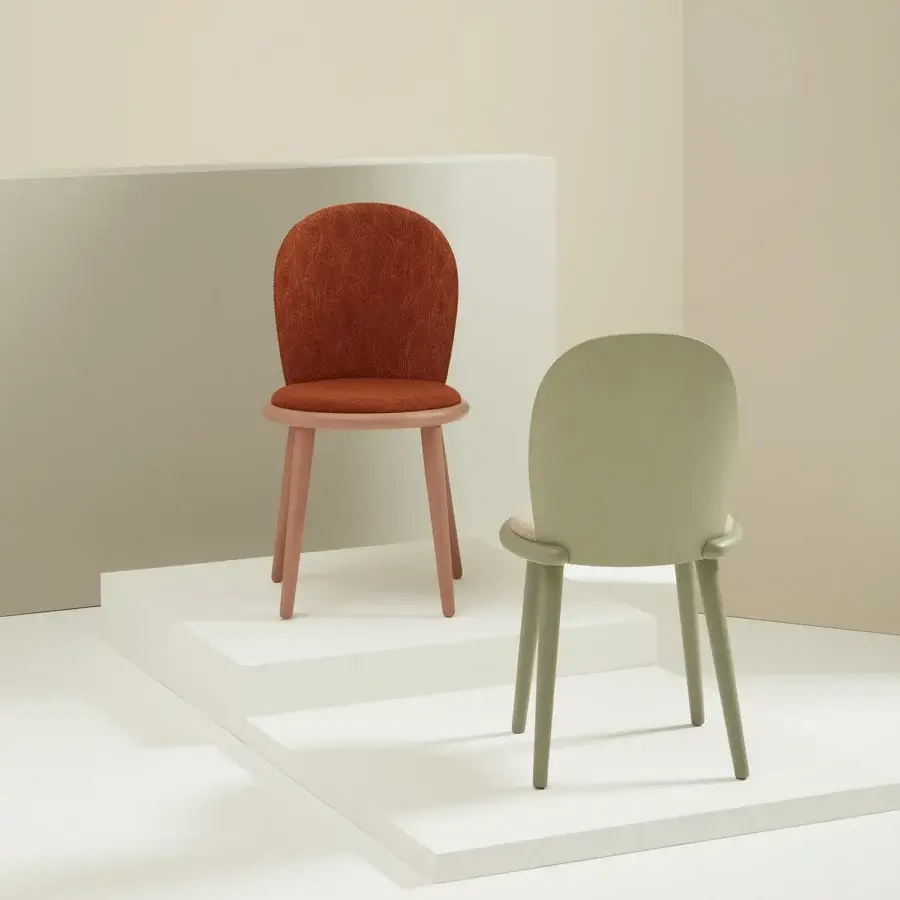Lavish Billiani Veretta dining chair in reddish-brown textile upholstery with matte muted pink beechwood legs exhibiting handcrafted detailing