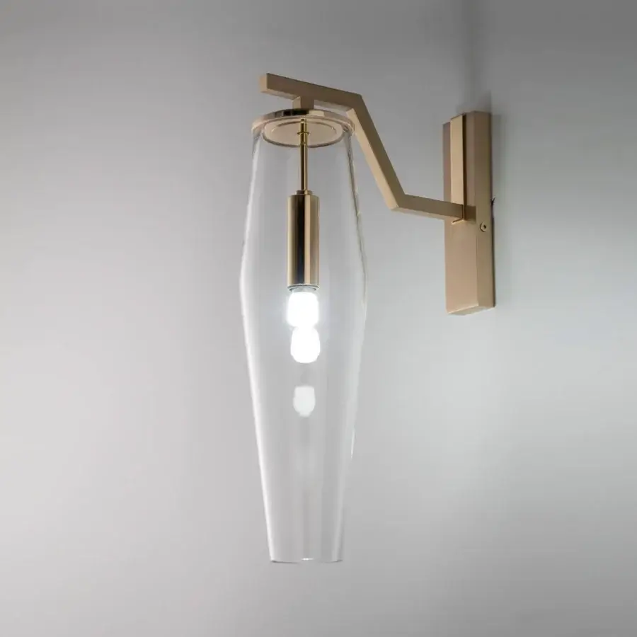 Elegant Patrizia Garganti Frida wall lamp with soft curves crafted in hand-blown glass and muted gold-tone metal with a satin finish