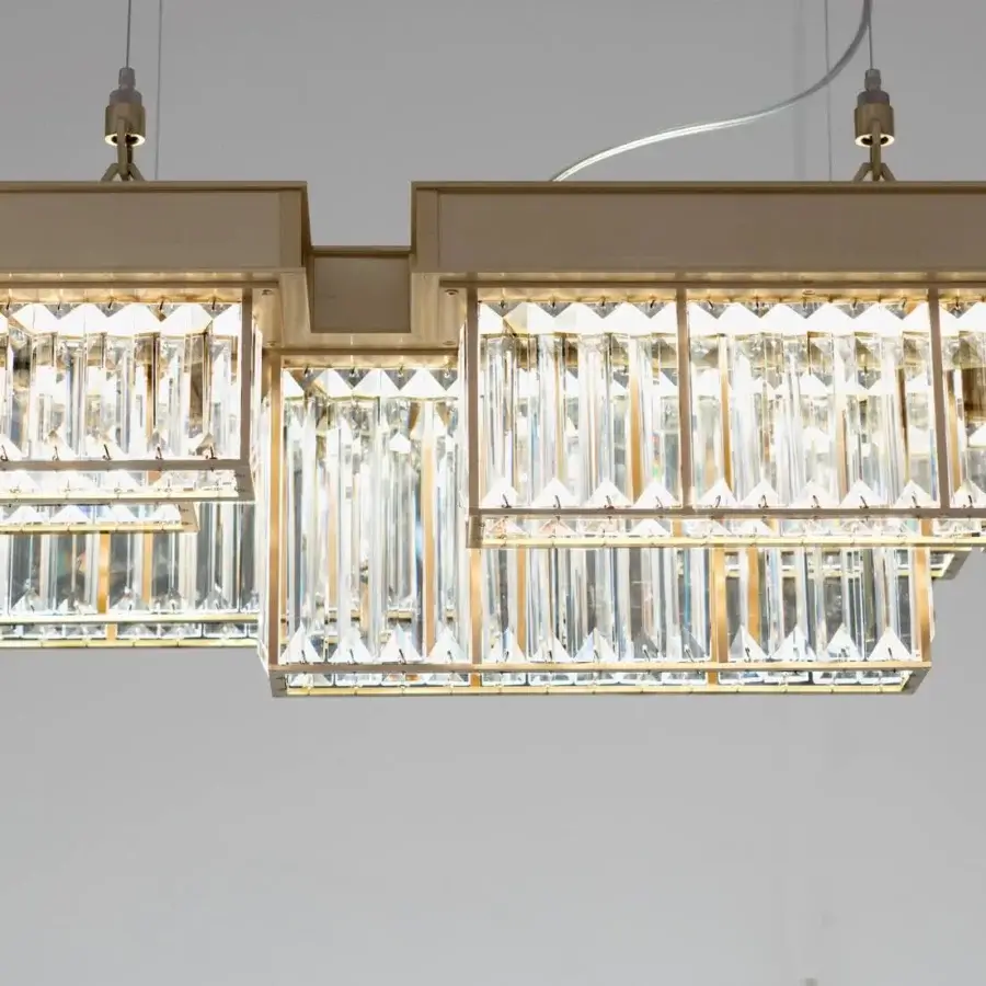 Exclusive Patrizia Garganti Gisele suspension lamp crafted in laser-cut steel with light gold satin finish and clear crystal accents