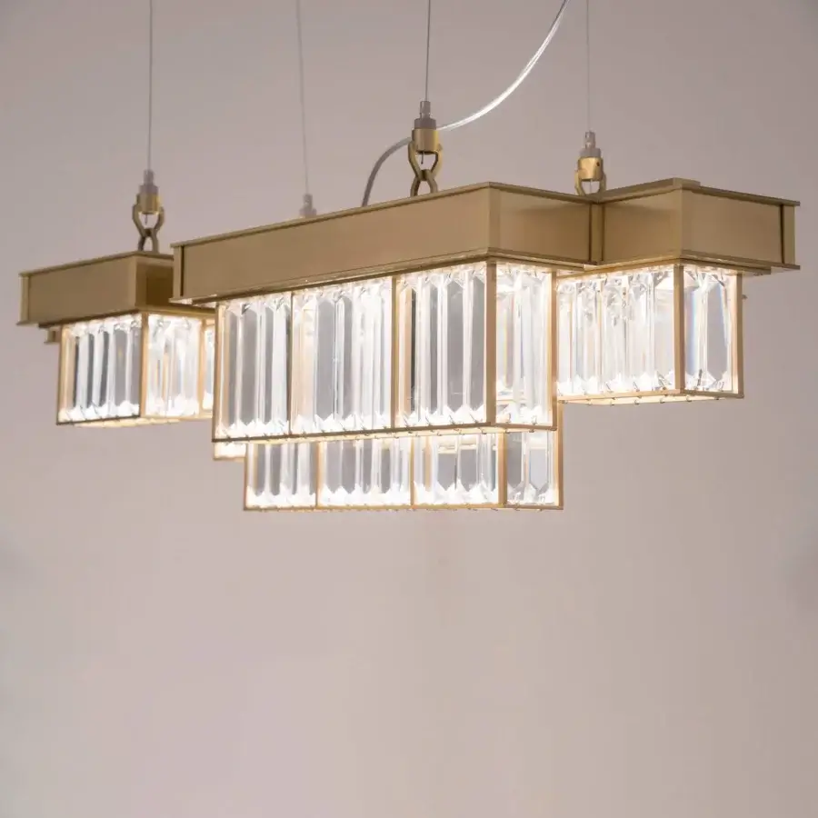 Superior Patrizia Garganti Gisele suspension lamp crafted in laser-cut steel with gold-toned finish and clear glass panels for warm illumination