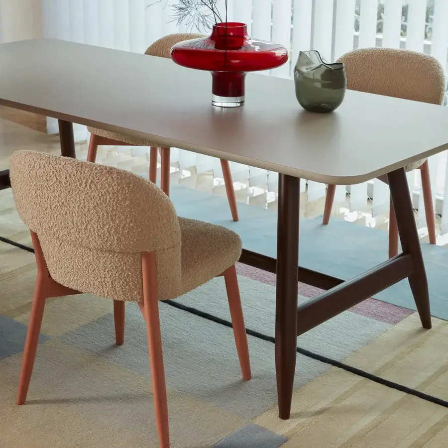 Elegant Billiani Spy dining chair upholstered in textured neutral beige boucle with reddish-brown satin tapered legs