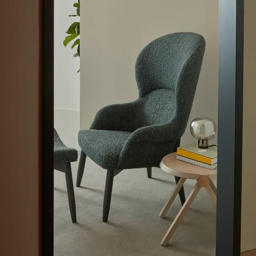 Distinguished Billiani Spy Lounge chair with enveloping form upholstered in textured dark teal-grey textile and dark-stained wooden base