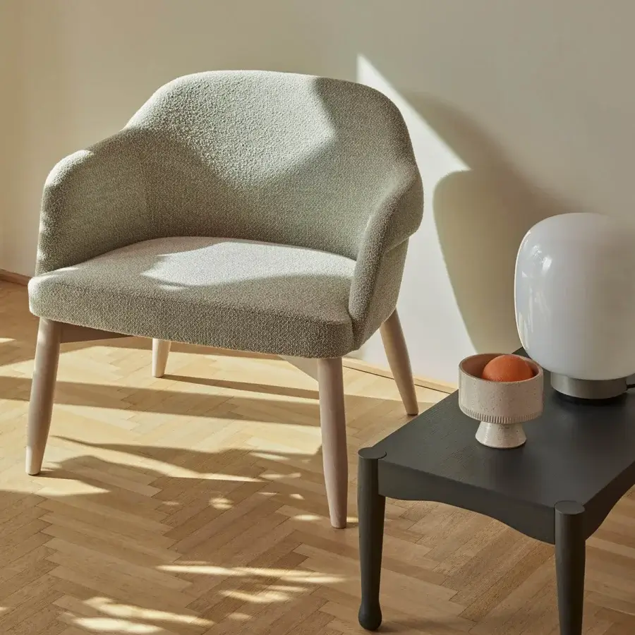 Superior Billiani Spy Lounge chair with gently curved form upholstered in muted sage green textile with satin-finished wooden base