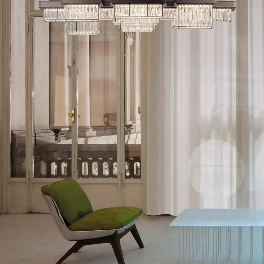Elegant Patrizia Garganti Gisele suspension lamp with linear transparent glass modules in a matte black laser-cut steel structure and warm white LED lighting