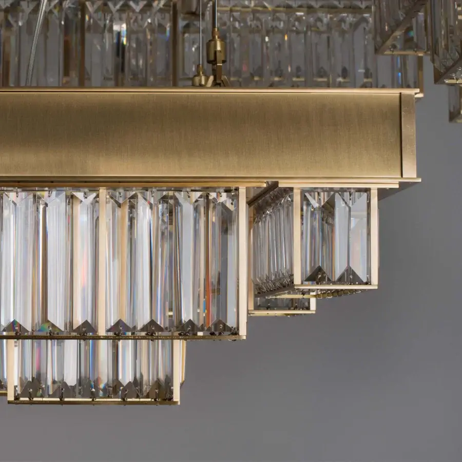 Exceptional Patrizia Garganti Gisele chandelier crafted in clear glass and warm gold with a geometric arrangement of laser-cut steel
