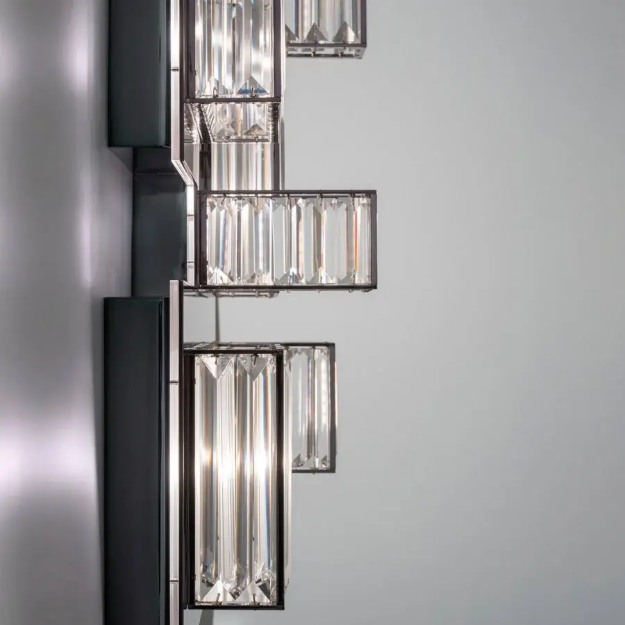 Elegant Patrizia Garganti Gisele wall lamp crafted in laser-cut steel with clear glass panels and a dark gray finish
