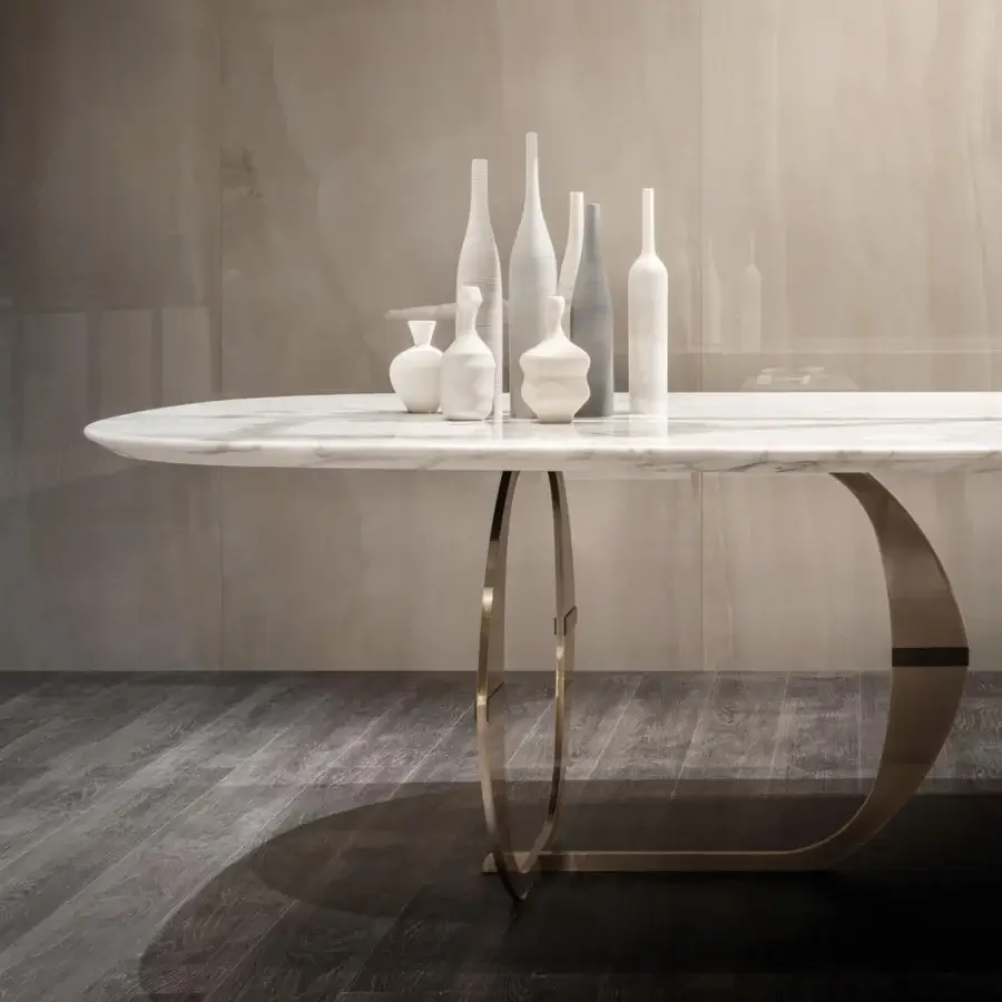 Elegant Capital Convivio table with sculpted white marble top and curved golden brushed metal base exhibiting a matt lacquered insert