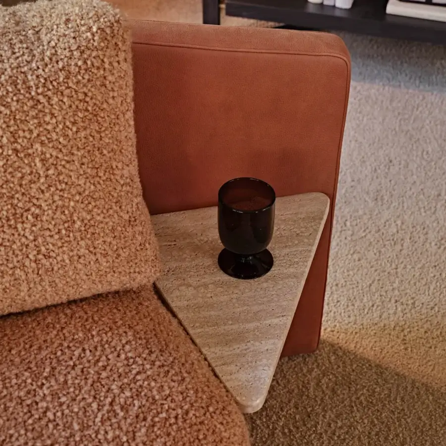 Distinguished Black Tie Lilith sofa with textured bouclé upholstery, reddish-brown leather armrests and built-in stone side table