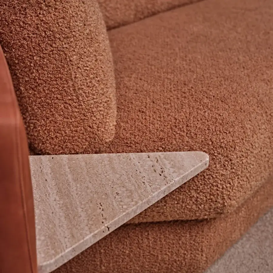 Exceptional Black Tie Lilith sofa with warm terracotta bouclé textile upholstery and matte travertine detail