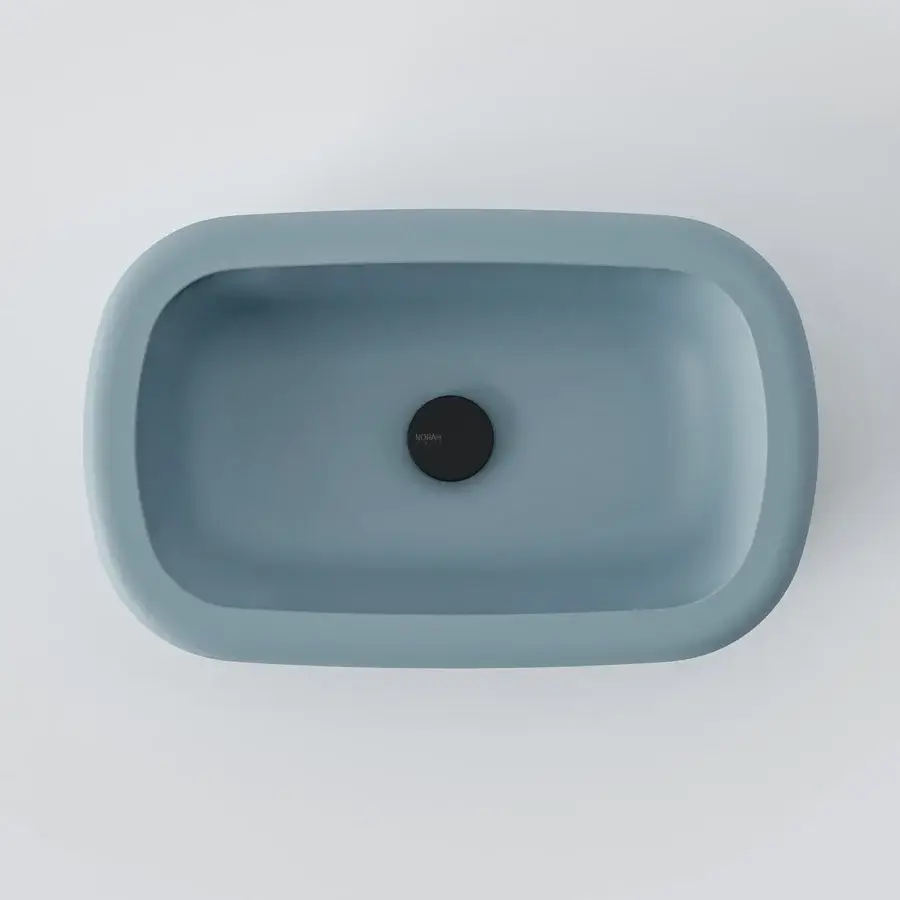 Elegant Norah Design ARBA 02 washbasin sculpted with an elongated oval form in dusty blue-grey Norahcryl with a velvety matte finish