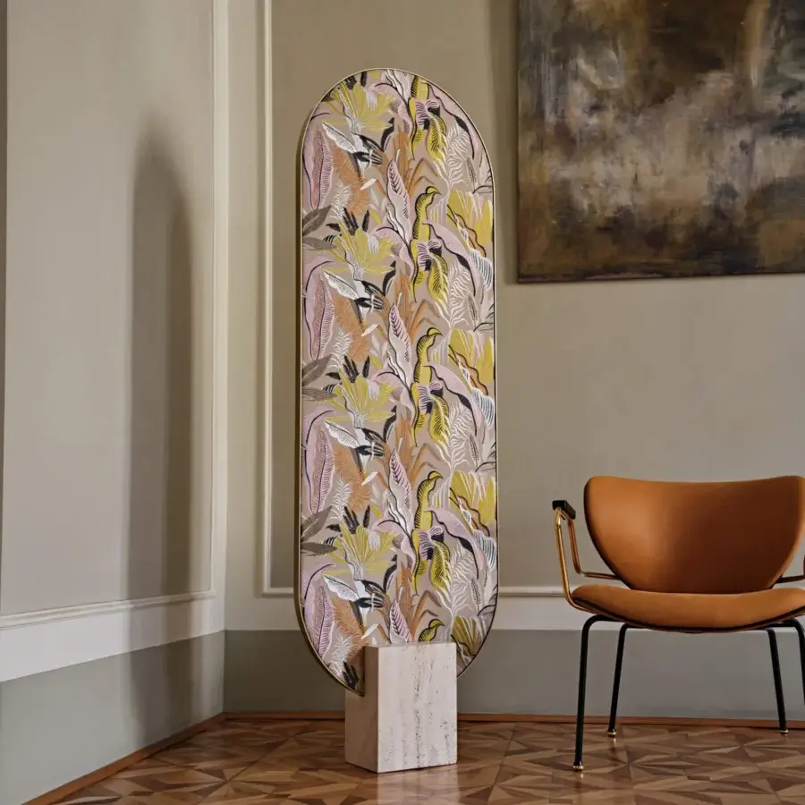 Exclusive Black Tie Tìam mirror with curved glass displaying ochre, pale pink, grey, and white botanical patterns in travertine