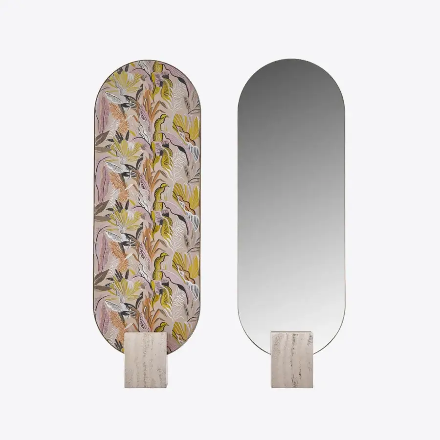 Elegant Black Tie Tìam mirror with curved reflective glass emerging from a majestic travertine base and botanical design in muted tones