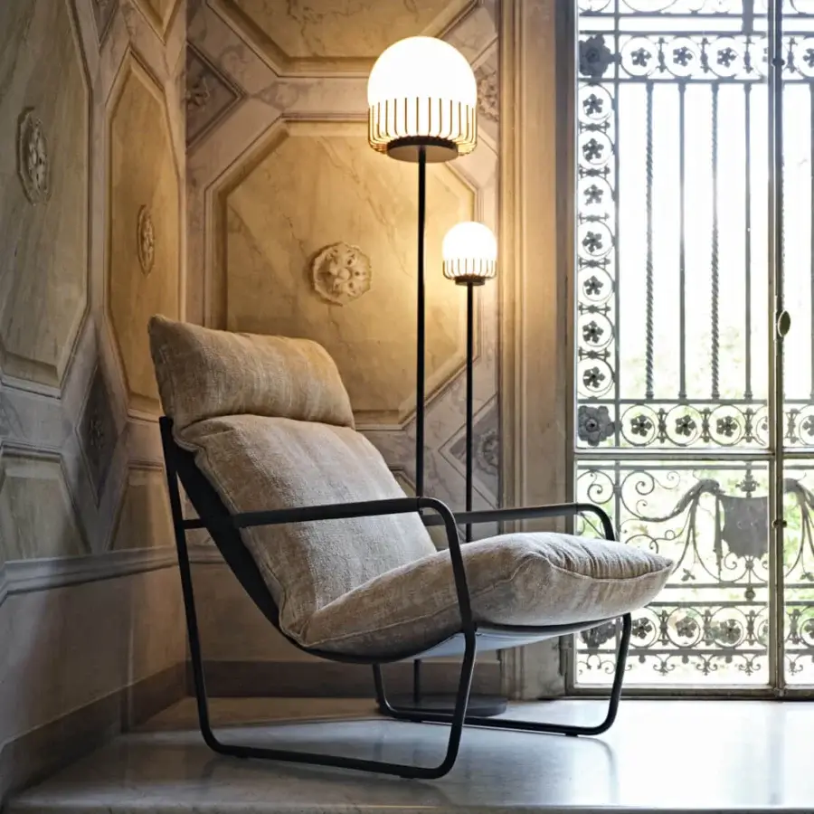 Sophisticated Black Tie Clizia lounge chair with matte black metal frame and light beige textured textile upholstery