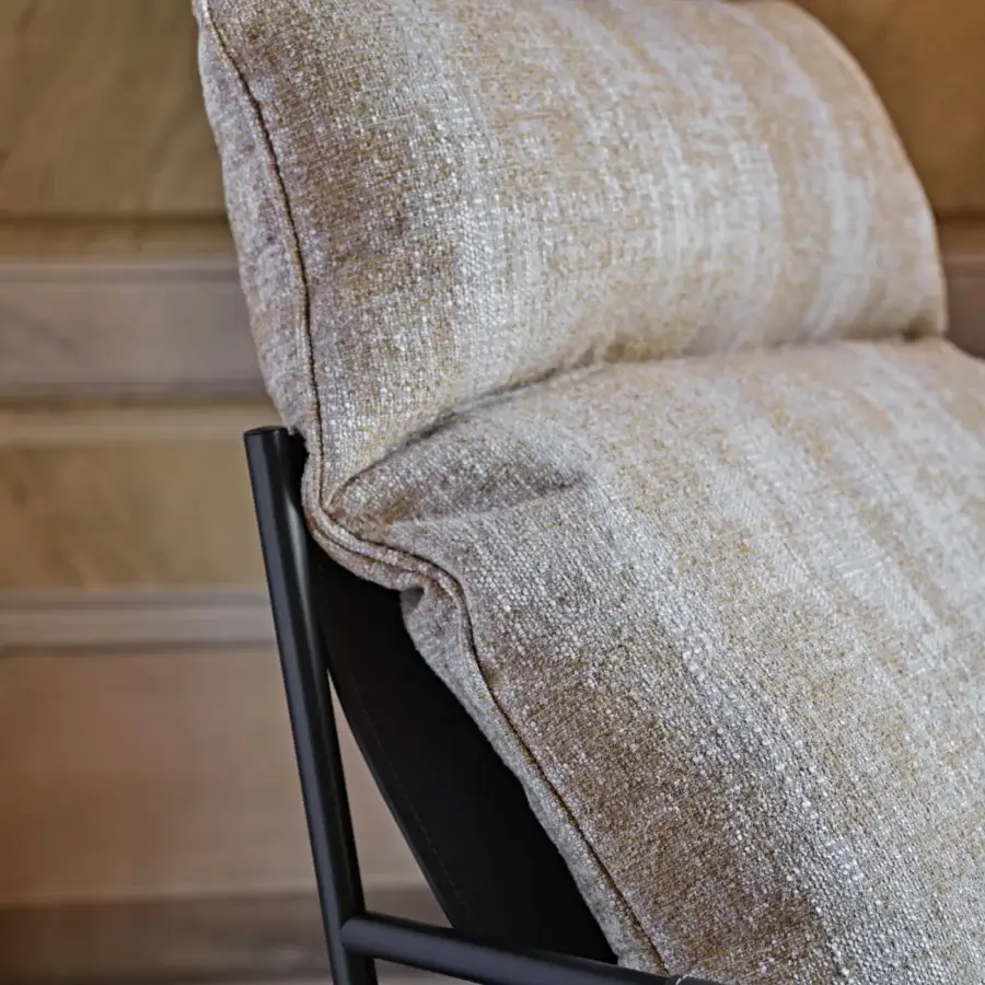 Distinguished Black Tie Clizia lounge chair with warm beige textile upholstery and slender matte black metal frame